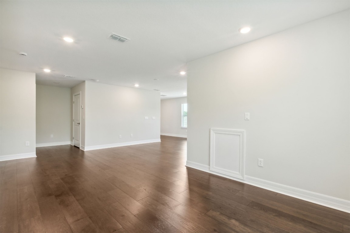 840 Continuum Loop Yulee, FL 32097 - Photo 38 of 64 a view of an empty room with wooden floor and a window