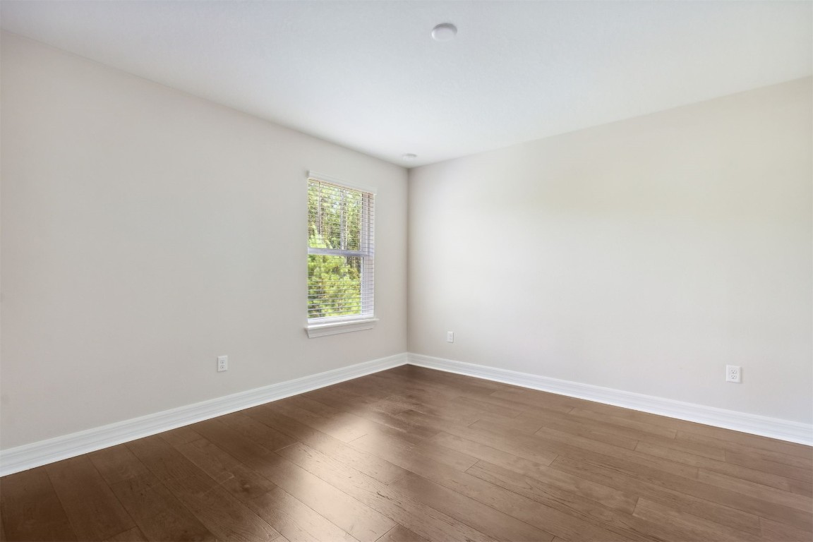 840 Continuum Loop Yulee, FL 32097 - Photo 39 of 64 an empty room with wooden floor and window
