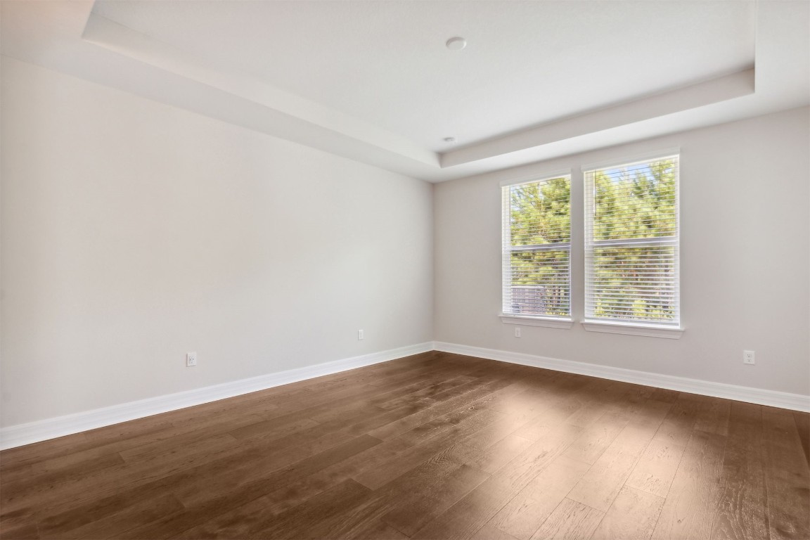 840 Continuum Loop Yulee, FL 32097 - Photo 4 of 64 a view of an empty room with wooden floor and a window