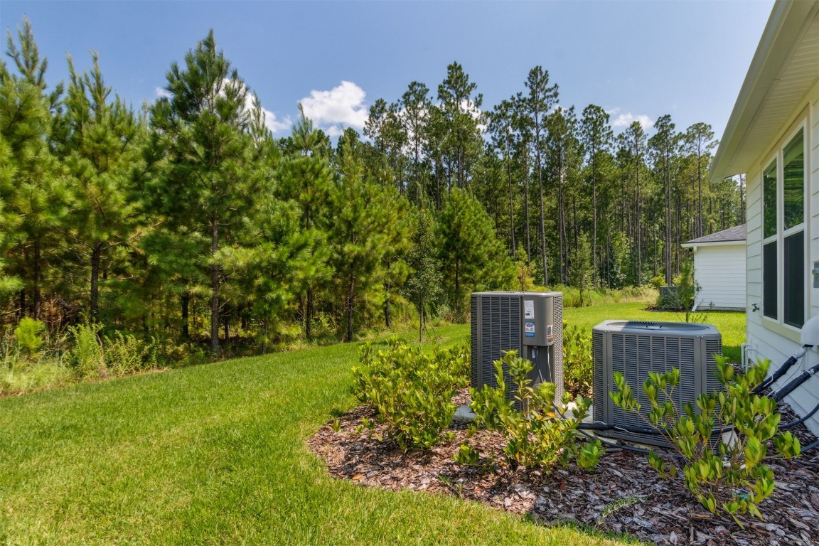 840 Continuum Loop Yulee, FL 32097 - Photo 48 of 64 a view of a garden with wooden fence