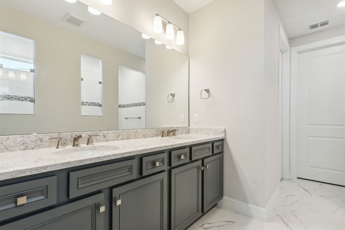 840 Continuum Loop Yulee, FL 32097 - Photo 5 of 64 a bathroom with a granite countertop sink and a mirror