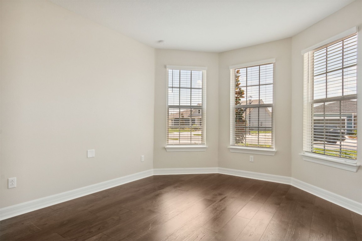 840 Continuum Loop Yulee, FL 32097 - Photo 6 of 64 an empty room with wooden floor and windows