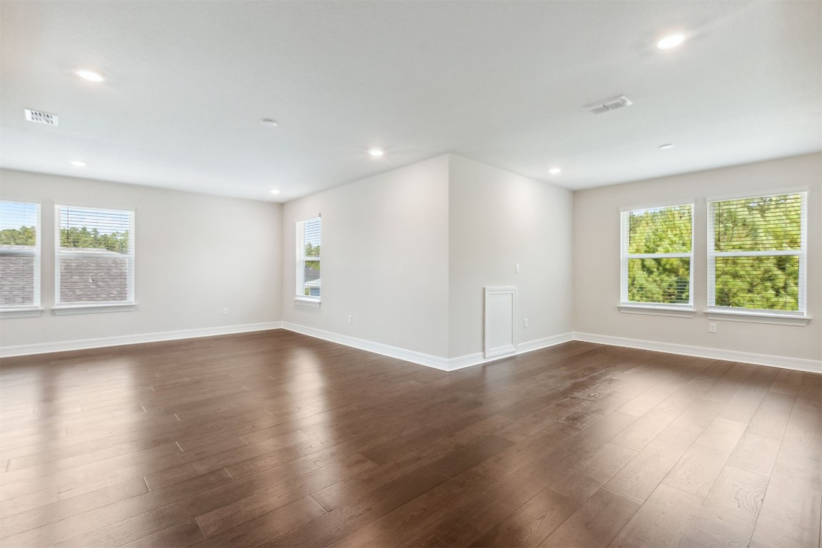 840 Continuum Loop Yulee, FL 32097 - Photo 9 of 64 an empty room with wooden floor and windows