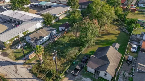 an aerial view of a house with garden space and street view