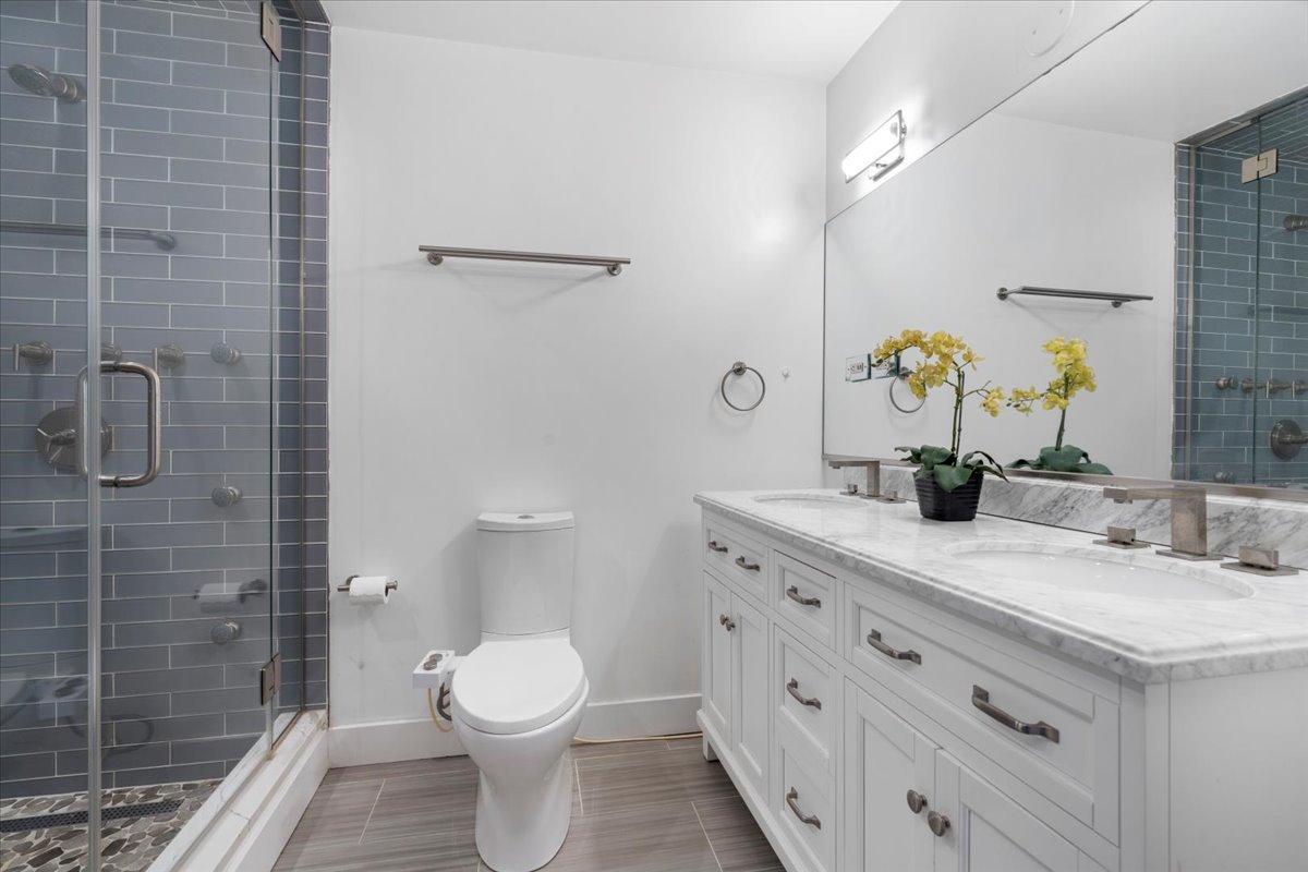 680 North Green Street, Unit 412 Chicago, IL 60642 - Photo 13 of 20 a bathroom with a granite countertop toilet sink and shower