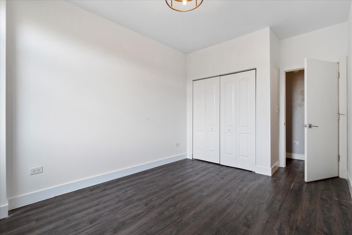 680 North Green Street, Unit 412 Chicago, IL 60642 - Photo 14 of 20 a view of an empty room with wooden floor