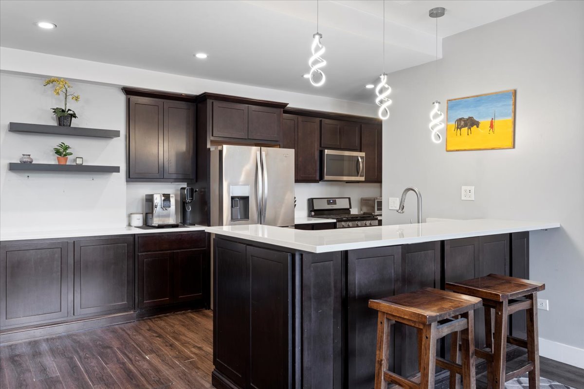 680 North Green Street, Unit 412 Chicago, IL 60642 - Photo 3 of 20 a kitchen with stainless steel appliances a sink stove and refrigerator