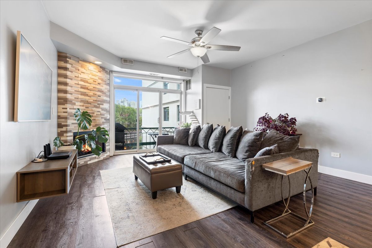 680 North Green Street, Unit 412 Chicago, IL 60642 - Photo 6 of 20 a living room with furniture and wooden floor