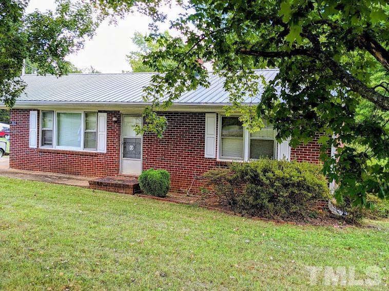 362 Tinker Road Chase City, VA 23924 - Photo 1 of 21 a front view of a house with garden
