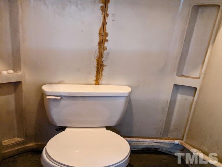 362 Tinker Road Chase City, VA 23924 - Photo 18 of 21 a white toilet sitting next to a shower
