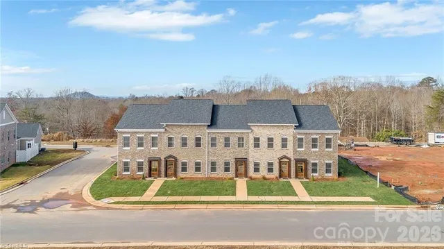 a view of residential houses with a yard and staircase