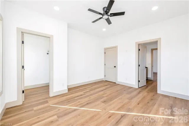 a view of a livingroom with a ceiling fan and entryway