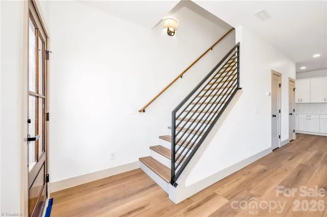 an entryway with stairs and a window