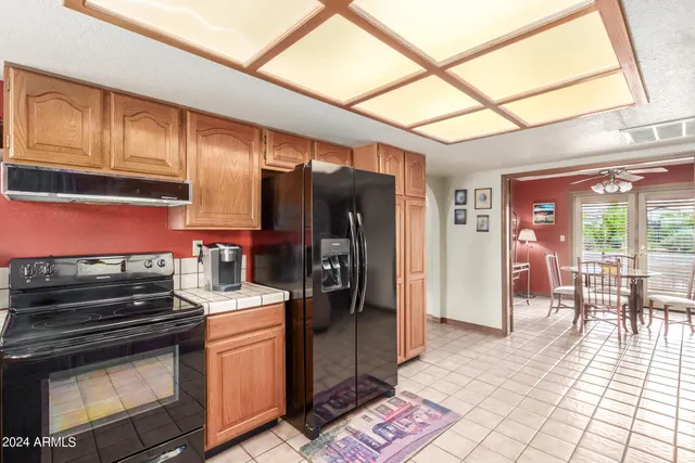 a bedroom with a bed and a flat tv screen on dresser