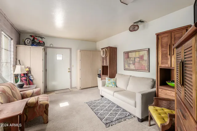 a bedroom with furniture and a flat screen tv
