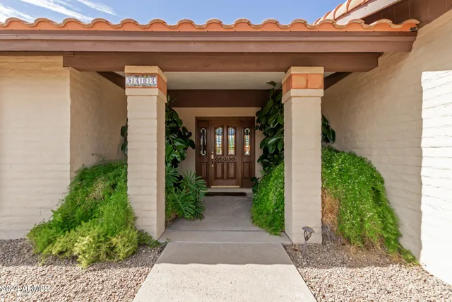a view of front door and potted plants