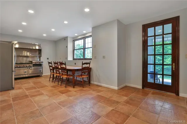 a view of a kitchen with a dining table and chairs