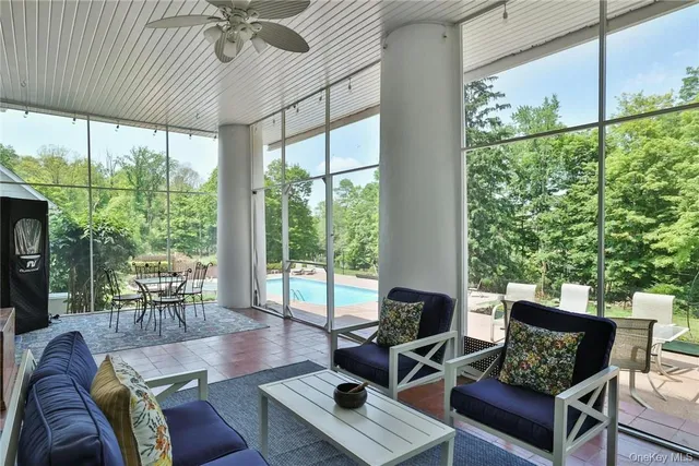 a living room with furniture tv and a large window