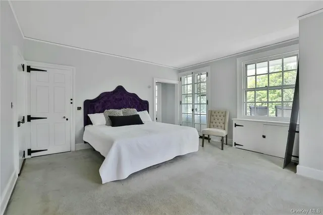 a bed room with a bed and a large window