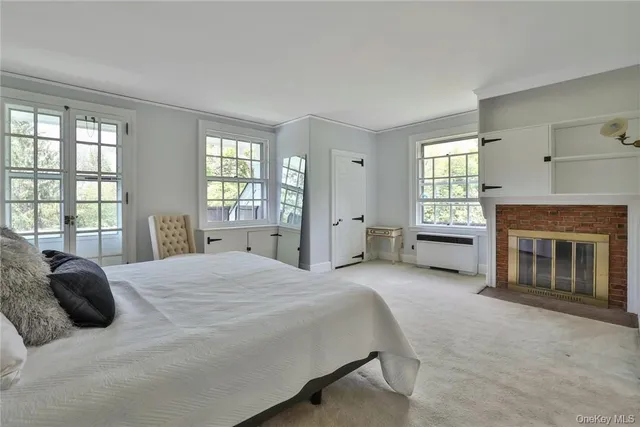 a spacious bedroom with a bed and a fireplace