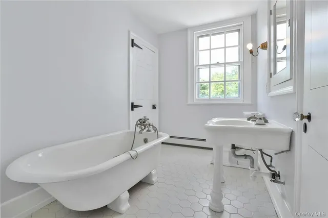 a bathroom with a bathtub and a sink