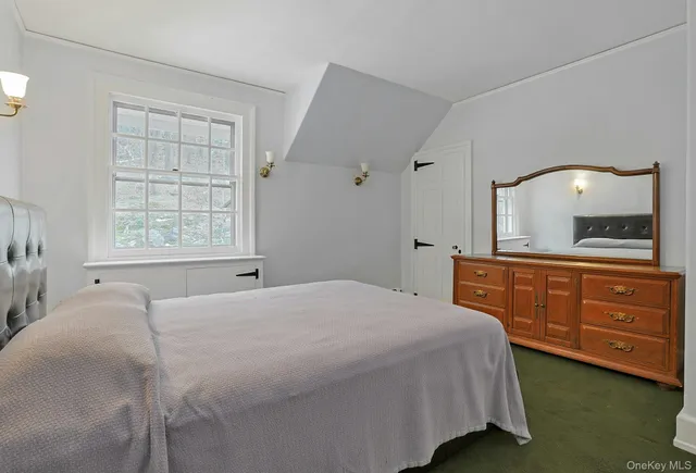 a bedroom with a large bed and a dresser