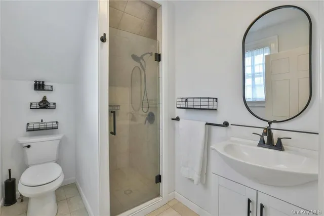 a bathroom with a toilet a sink and a mirror