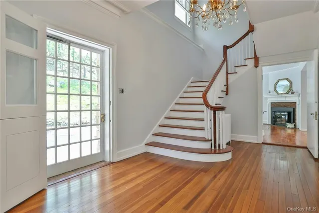 a view of entryway and hall with wooden floor