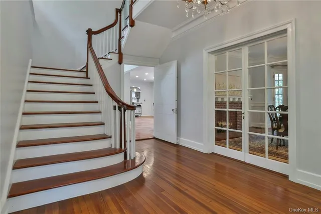 a view of entryway with wooden floor and stairs