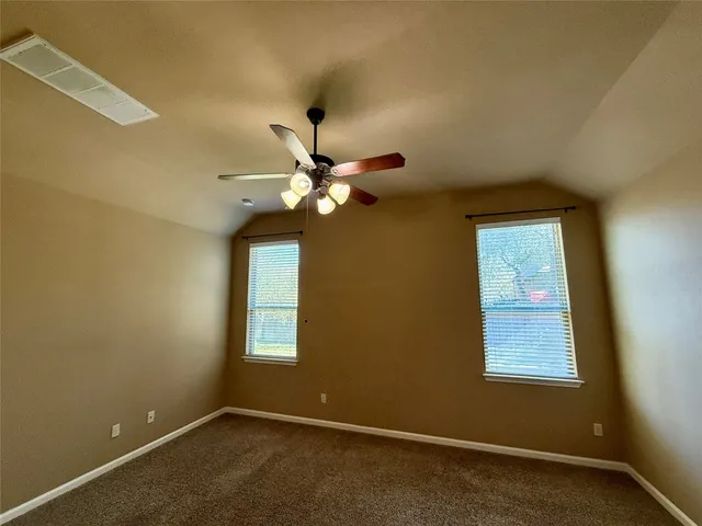 a view of room with window and ceiling fan