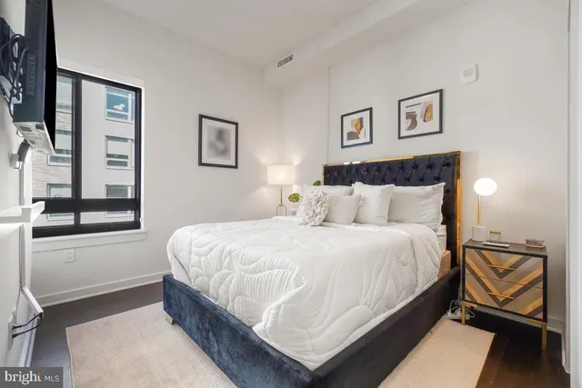 a bedroom with a bed and window