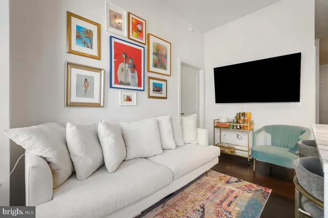 a living room with furniture and a flat screen tv