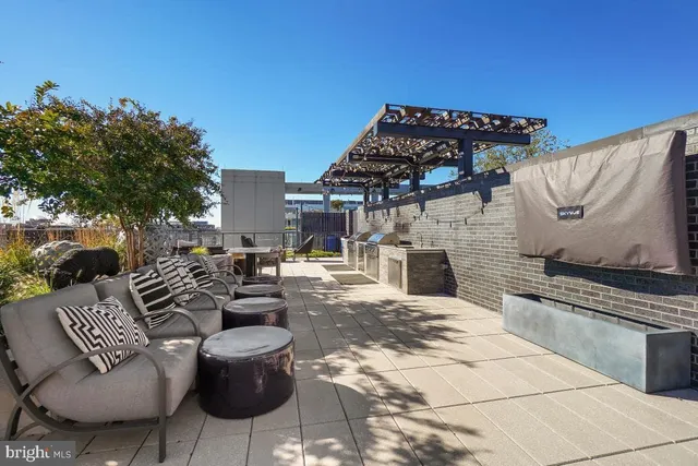 a view of a patio with couches chairs and a fire pit