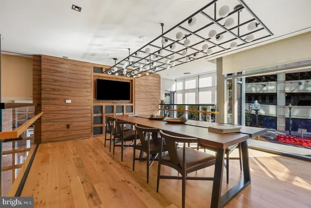 a living room with lots of furniture and view of kitchen