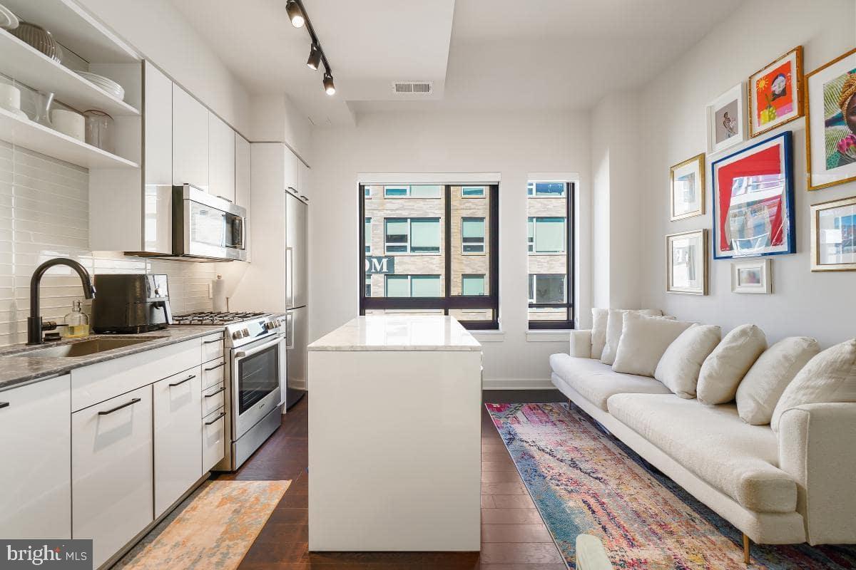 70 N Street Southeast, Unit N1016 Washington, DC 20003 - Photo 3 of 21 a living room with furniture and a kitchen
