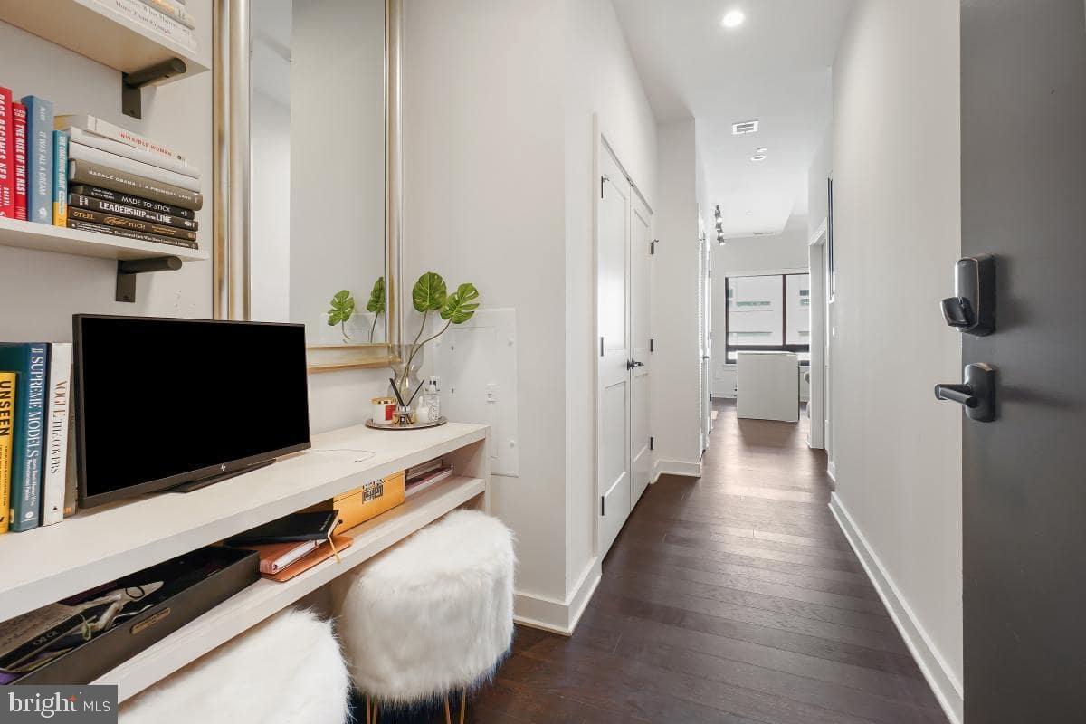 70 N Street Southeast, Unit N1016 Washington, DC 20003 - Photo 5 of 21 a hallway with view of living room and flat screen tv