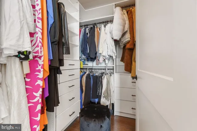 a view of walk in closet with clothes