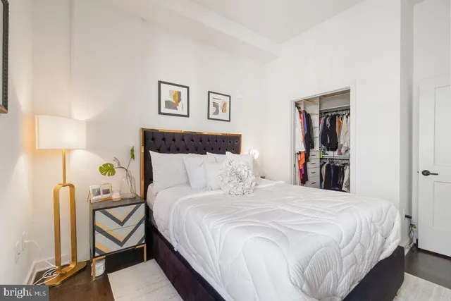 a bedroom with a bed and a lamp on table