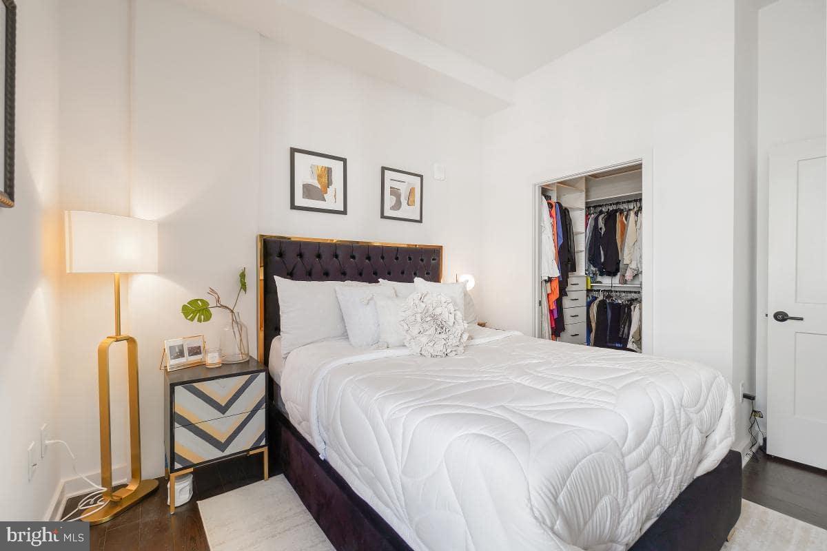 70 N Street Southeast, Unit N1016 Washington, DC 20003 - Photo 8 of 21 a bedroom with a bed and a lamp on table