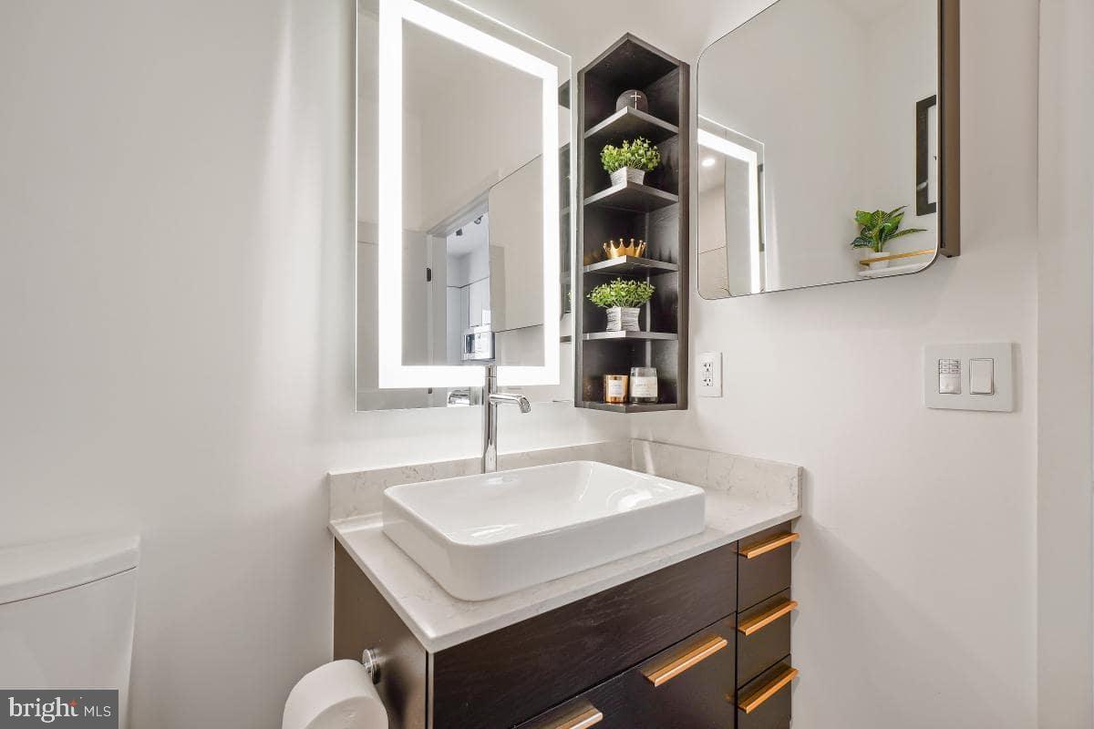 70 N Street Southeast, Unit N1016 Washington, DC 20003 - Photo 9 of 21 a bathroom with a sink and a mirror