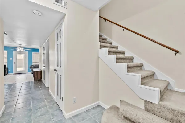 a view of a hallway with wooden floor and entryway