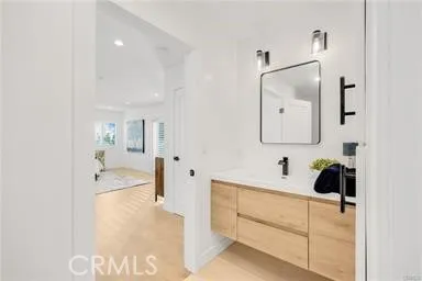 a patio with a table and chairs under an umbrella with a barbeque