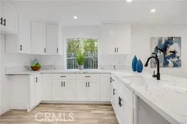a kitchen with granite countertop a sink and cabinets