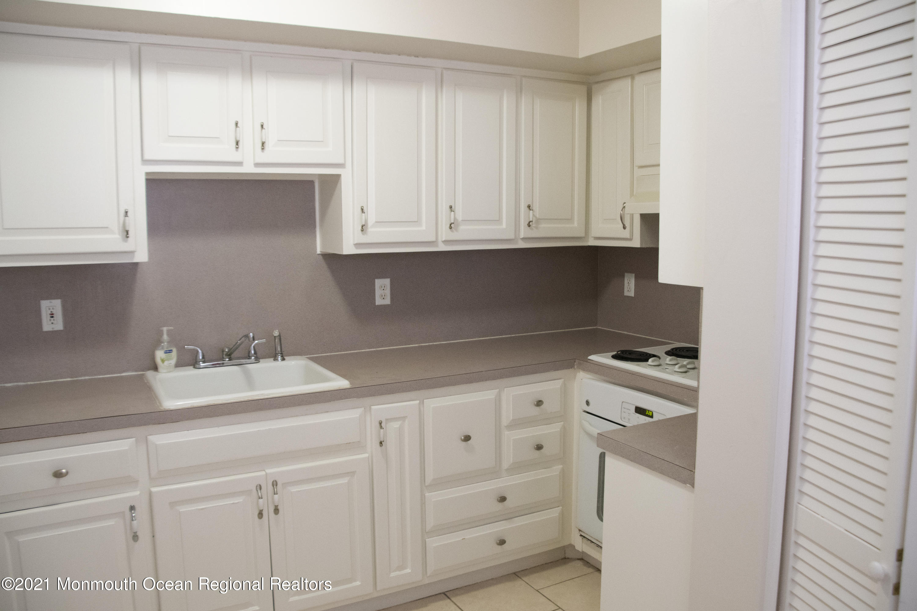 326 Sawmill Road, Unit 132 Brick, NJ 08724 - Photo 1 of 18 a kitchen with granite countertop white cabinets and sink
