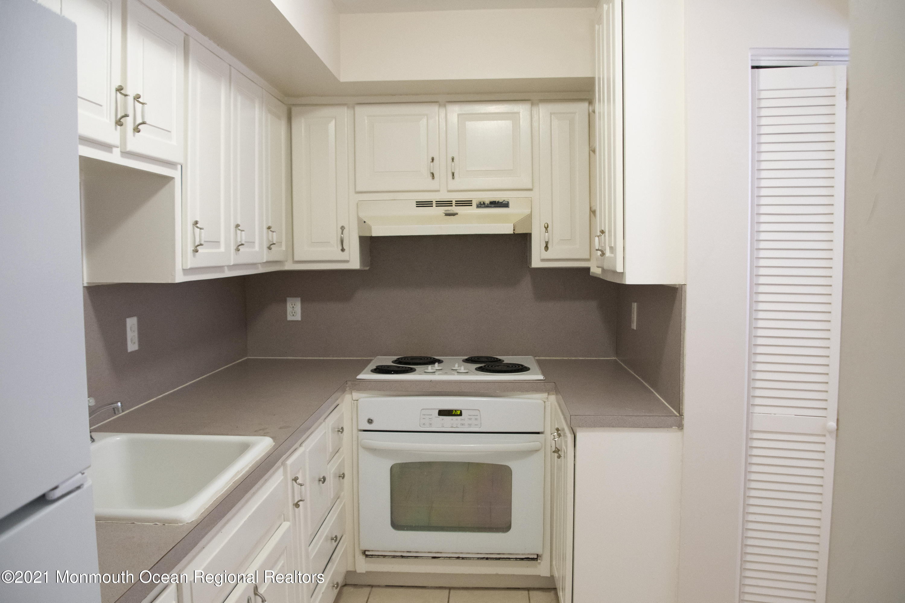 326 Sawmill Road, Unit 132 Brick, NJ 08724 - Photo 2 of 18 a kitchen with granite countertop white cabinets and white appliances