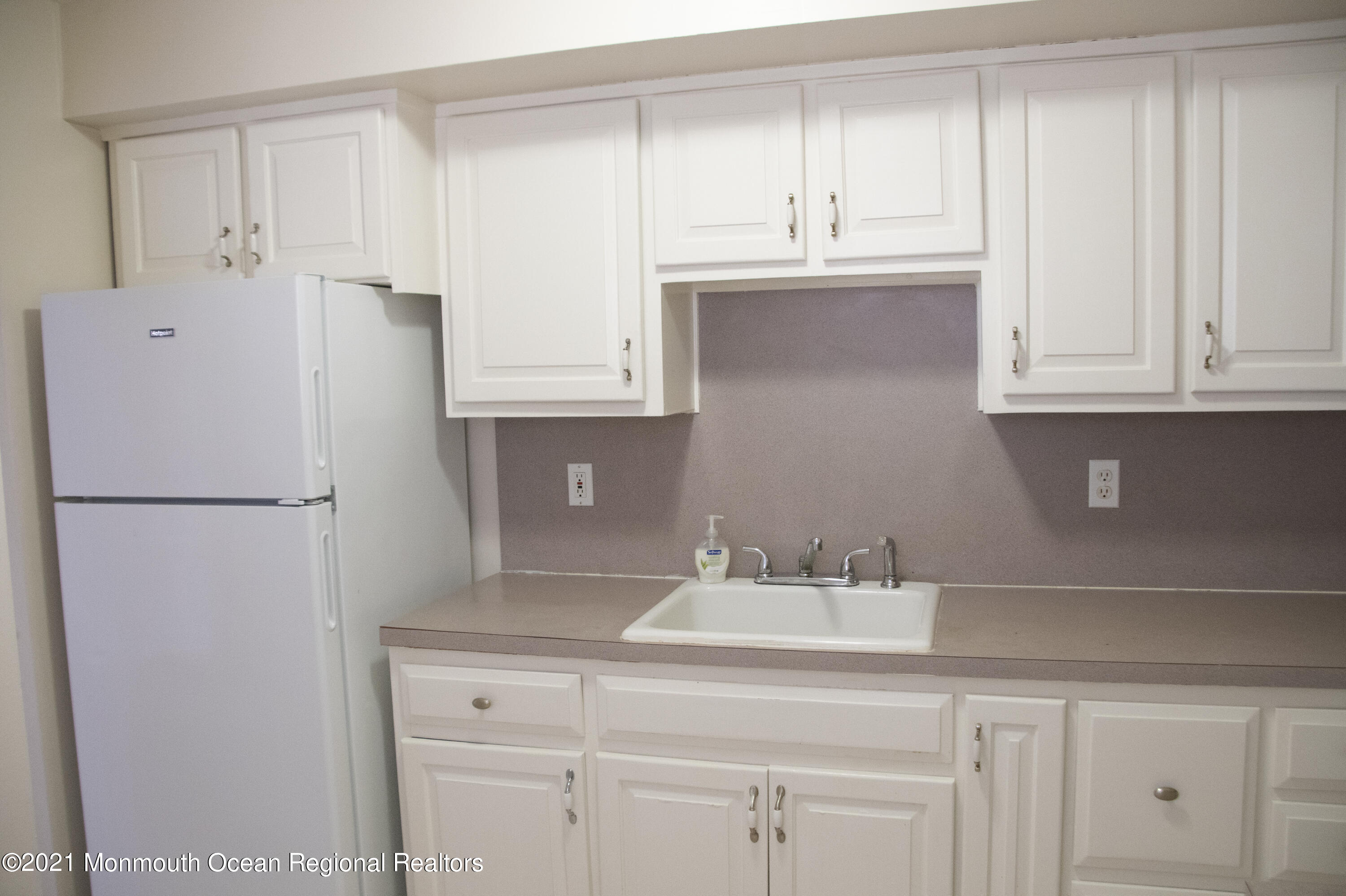 326 Sawmill Road, Unit 132 Brick, NJ 08724 - Photo 3 of 18 a kitchen with granite countertop white cabinets and refrigerator