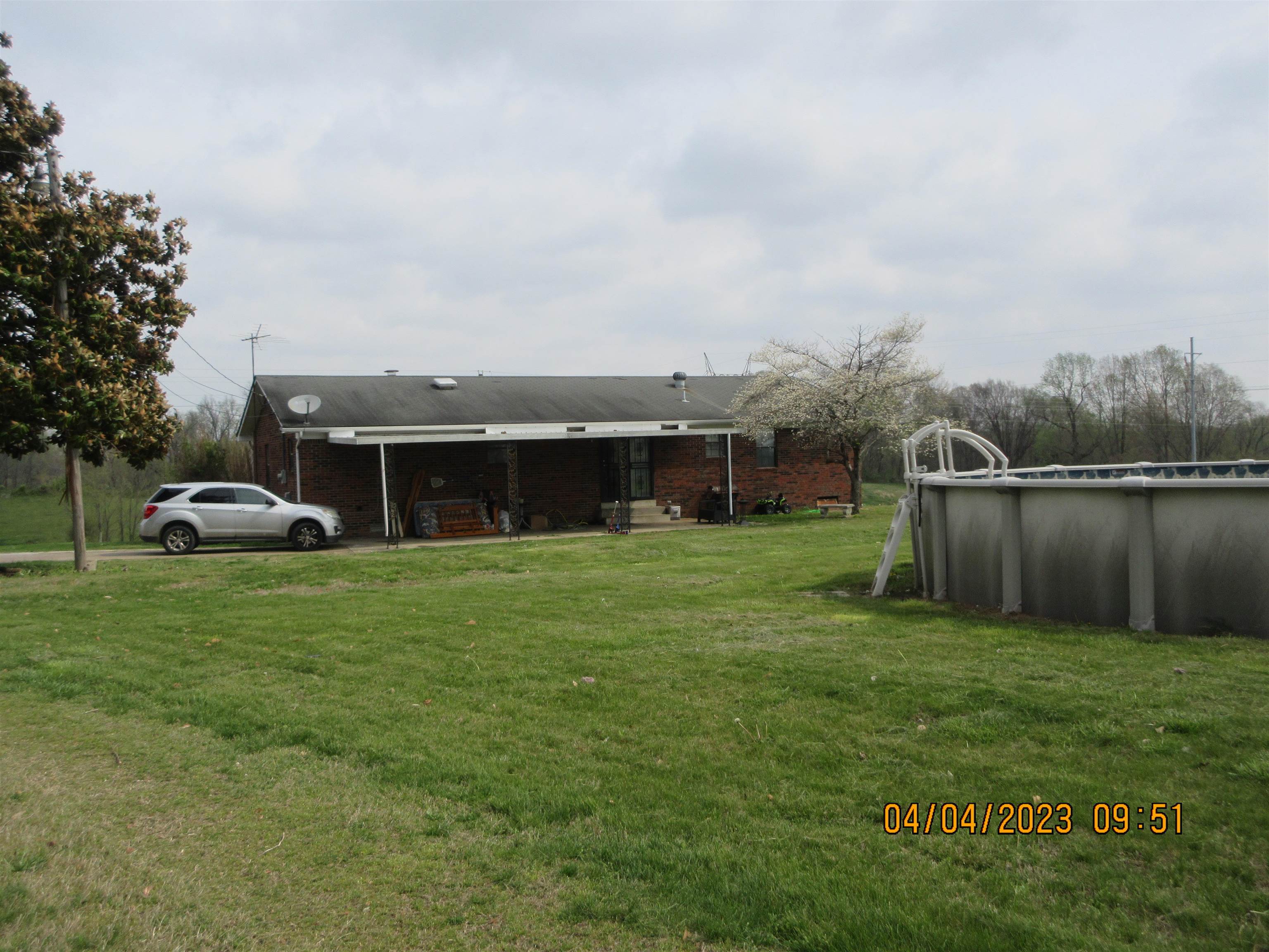 1211 Dry Hill Road West Ripley, TN 38063 - Photo 9 of 12 a front view of a house with a garden and trees