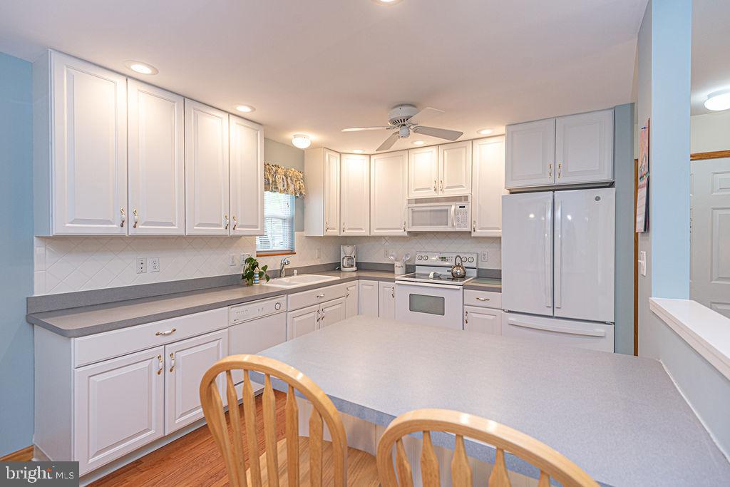 199 Windjammer Road Ocean Pines, MD 21811 - Photo 15 of 62 a kitchen with granite countertop white cabinets and stainless steel appliances