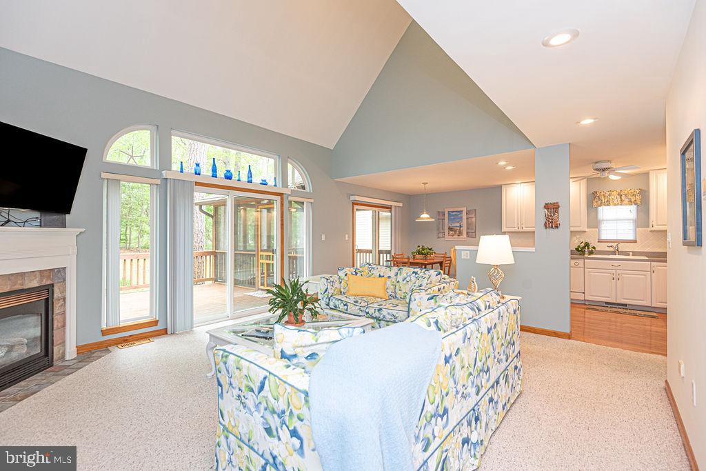 199 Windjammer Road Ocean Pines, MD 21811 - Photo 9 of 62 a living room with furniture a flat screen tv and a fireplace