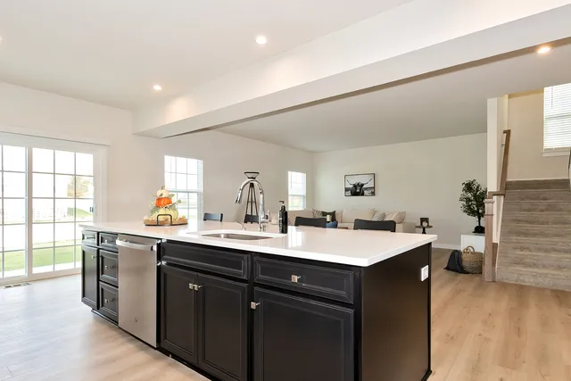 a kitchen with a sink stove and cabinets